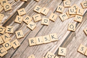 Tiles spell out the word risk